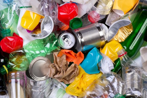 Staff sorting recyclables into designated bins at site